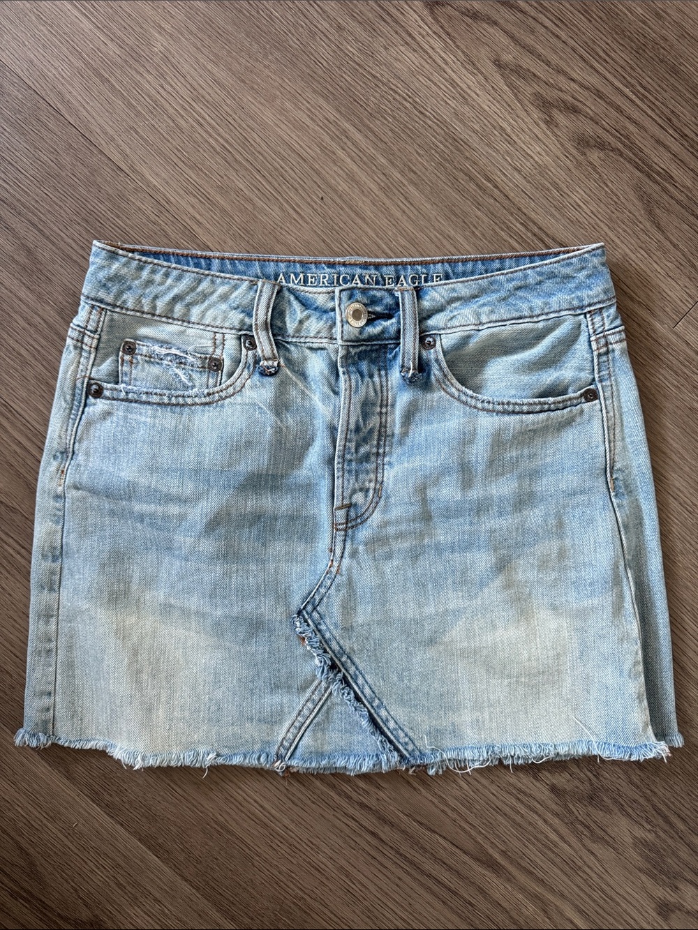 American Eagle Outfitters Light Wash Denim Mini Skirt with Raw Hem